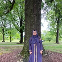 Muntaha Hossain standing in front of a tree